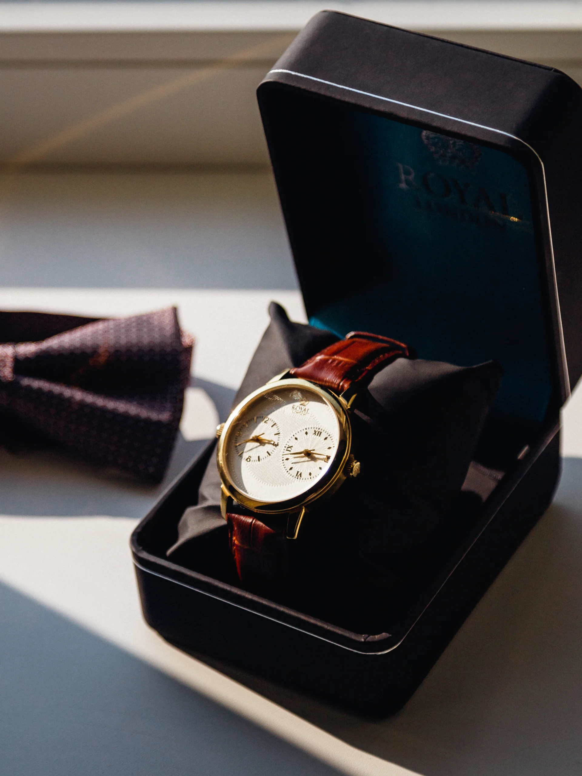 watch-black-box-bow-tie-lie-white-windowsill